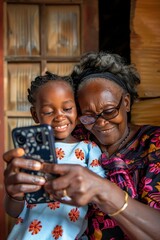 Wall Mural - grandmother with her granddaughter taking a selfie