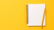 A white notepad, devoid of content, rests open alongside a pencil on a yellow background, photographed from a top perspective, providing space for additional text.