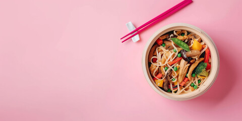 Wall Mural - A bowl of food with chopsticks on a pink background