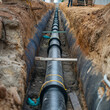 © Krystian - Underground water pipeline installation in trench, infrastructure development for urban water supply system, civil engineering construction