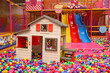 Slides, playhouse and many colorful balls in ball pit