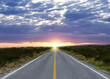 © New Africa - Empty asphalt road through field at sunset