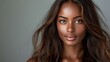 A close-up portrait of a beautiful black woman with long shiny hair and make-up . Haircare, beauty and cosmetics concept.