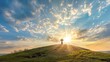 This dramatic Easter Morning Sunrise panorama with blue sky, bright clouds, sunbeams, and large cross on a grass covered hill makes a great banner cover for print or web.