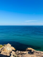 Wall Mural - Blue ocean horizon, rocky coast, ocean bay