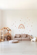© sergiophoto - Kids room interior in contemporary, Scandinavian style. Wooden bed, sofa and toys. Cozy room for child.