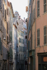 Romantic backstreet road alley in historic old town downtown Toulon, France with Mediterranean style house building facades and old little piazzas fountains picturesque city scenery