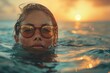 A woman with stylish sunglasses faces the camera, half submerged in sea water at sunset