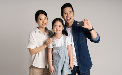 Wall Mural - Asian family portrait posing on white background