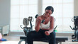 © NT_studio - Young black woman training exercise or workout with lifting dumbbell for bodybuilder with strong in fitness gym, woman practicing weightlifting for strength of muscle and motivation, sport concept.