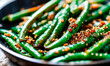 green beans with sesame seeds in a frying pan. Selective focus.