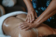 A professional massage therapist giving a relaxing massage to a client, using gentle motions to ease tension and promote well-being