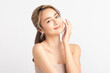 © Shutter B - Happy beautiful young asian woman smile touching her face on white background, clean fresh bare skin concept. Facial treatment, Perfect skin, Natural make up.