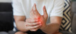 © chinnarach - close up employee man massage on hand palm after hard working to relief pain of stiffness or cramp or carpal tunnel for office syndrome concept