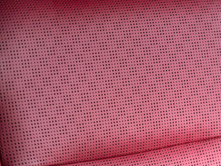 Wall Mural - Part of leather car headrest seat details. Сlose-up red   perforated leather car seat. Skin texture