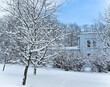 Panorama of a snow-covered park with snowy trees in cloudy day in the Mezaparks district, Riga	
