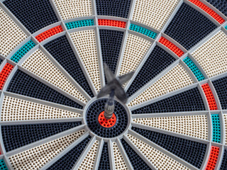 dart board with darts. dart in the target. concept hitting the target