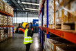 © ultramansk - operation worker woman checking and inspecting cargo for stack items for shipping. Staff checking the store factory. industry factory warehouse. Worker Scanning Package In Warehouse.