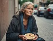 A homeless woman is sitting on the sidewalk. She is hungry. She begs for eat on the urban street