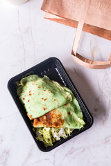 Canvas Print - Fried green thin pancakes of spinach with coleslaw in plastic box.