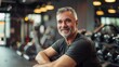 © Elmira - A man smiles at the camera in a gym environment, showcasing his workout routine and positive attitude