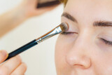 Fototapeta  - Makeup artist applying eye make up
