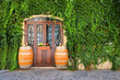 Old wine barrels outside a vine covered restaurant in Italy