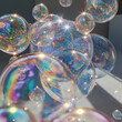 This image features a cluster of iridescent soap bubbles, reflecting a spectrum of colors and emitting sparkling light