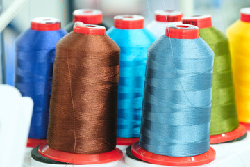 Aufkleber - Spools of color threads closeup, spinning machine