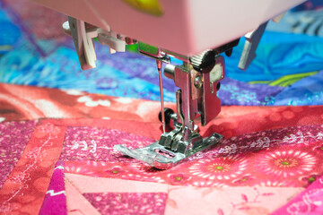 Wall Mural - Close-up detail of the sewing machine, Closeup modern sewing machine presser foot sewing fabric with thread Used for making clothes curtains and upholstery business hobby and handmade projects.