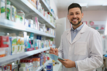 Poster - Professional pharmacist near shelves with merchandise in modern drugstore