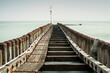 Sea pier with wooden poles and endless horizon of the sea