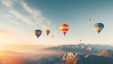wide foggy mountain range landscape with colorful hot air balloons flying in the sky 