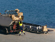 © DayfaPhoto - Municipal Worker Disposing of Cardboard Boxes into Waste Truck Seaside