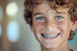 Portrait of a smiling 10 year old blond boy looking at camera in braces.