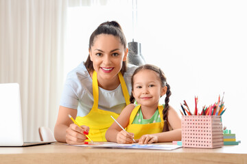 Canvas Print - Little girl with her working mother drawing in kitchen