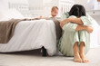 © Pixel-Shot - Young woman with her baby suffering from postnatal depression in bedroom