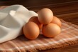 Chicken eggs on a napkin on a wooden table