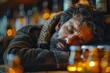 A person in a heavy coat slumps over in fatigue or despair at a dimly lit bar setting