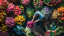 A Man Is Picking Flowers From A Flower Shop. The Shop Is Filled With A Variety Of Colorful Flowers, Including Roses, Daisies, And Sunflowers