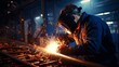 © Ilja - Professional welder working on medium sized pipe with blue light, close up metal welding process