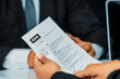 © Summit Art Creations - Human resources department manager reads CV resume document of an employee candidate at interview room. Job application, recruit and labor hiring concept. uds
