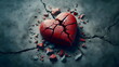 red stone heart smashed in a cracked concrete ground as a symbol for a broken heart and lovesickness