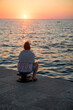 Relaxing woman watching the sunset in Rocinj - Croatia