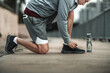 © Charnchai saeheng - A man tying shoelaces on sport shoes in the city center park before cardio workout, running.  Health and Lifestyle in big city life concept.