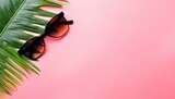 Fototapeta  - summer vacation flat lay, space for text. stylish black photo camera with green palm leaves, sunglasses and phone on trendy pink background. modern hipster travel image. on white background 