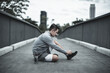 © Charnchai saeheng - A man tying shoelaces on sport shoes in the city center park before cardio workout, running.  Health and Lifestyle in big city life concept.