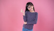© paulaphoto - Portrait of young fun smart happy little asian finger gesture mini heart girl on pink with copy space studio shot. Education for elementary kindergarten, little girl authentic thinking back to school