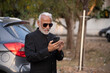 © Ojas - Lifestyle shot of senior Indian man wearing a suit working on a phone Digital India and digitally literate citizens