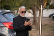© Ojas - Lifestyle shot of senior Indian man wearing a suit working on a phone Digital India and digitally literate citizens